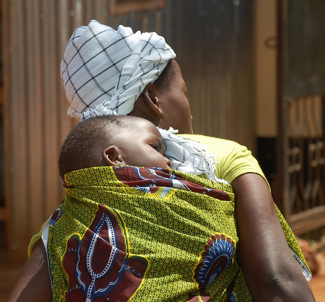 Kenyan woman with child on back