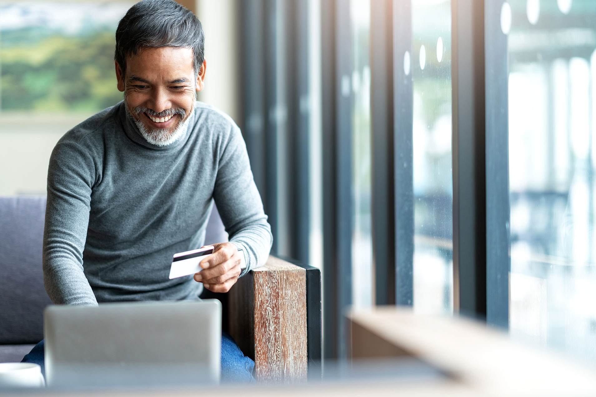 Person smiling looking at laptop
